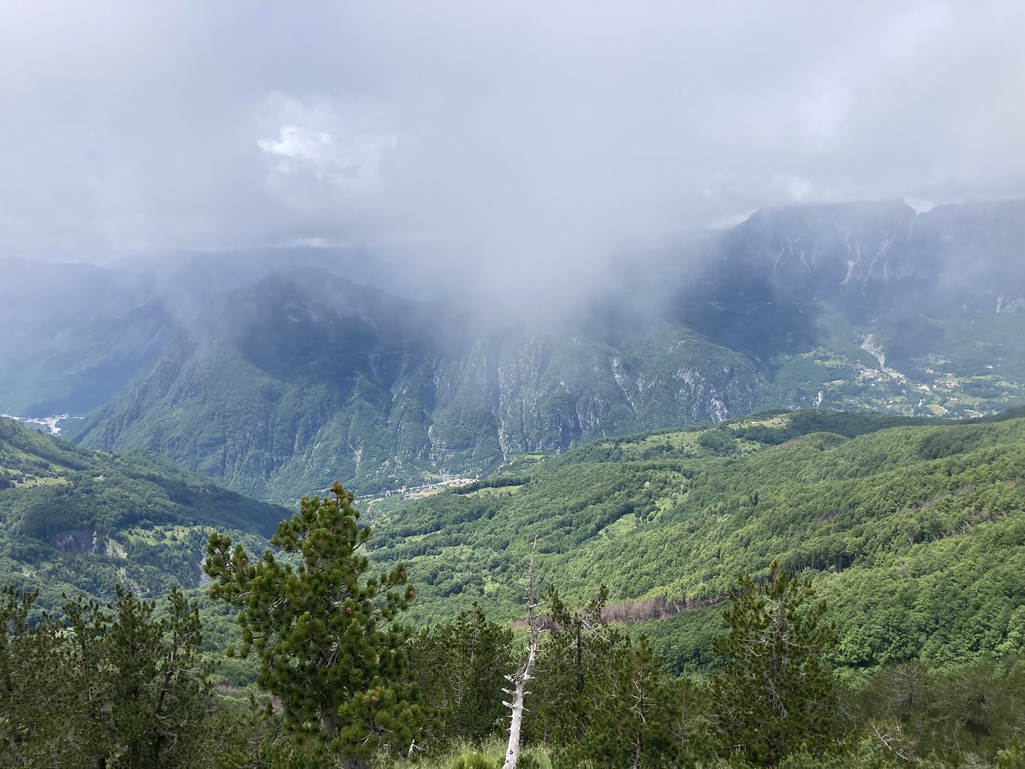 Clouds lifting from the summit of the Valbona to Theth pass, revealing a view of the Albanian Alps.